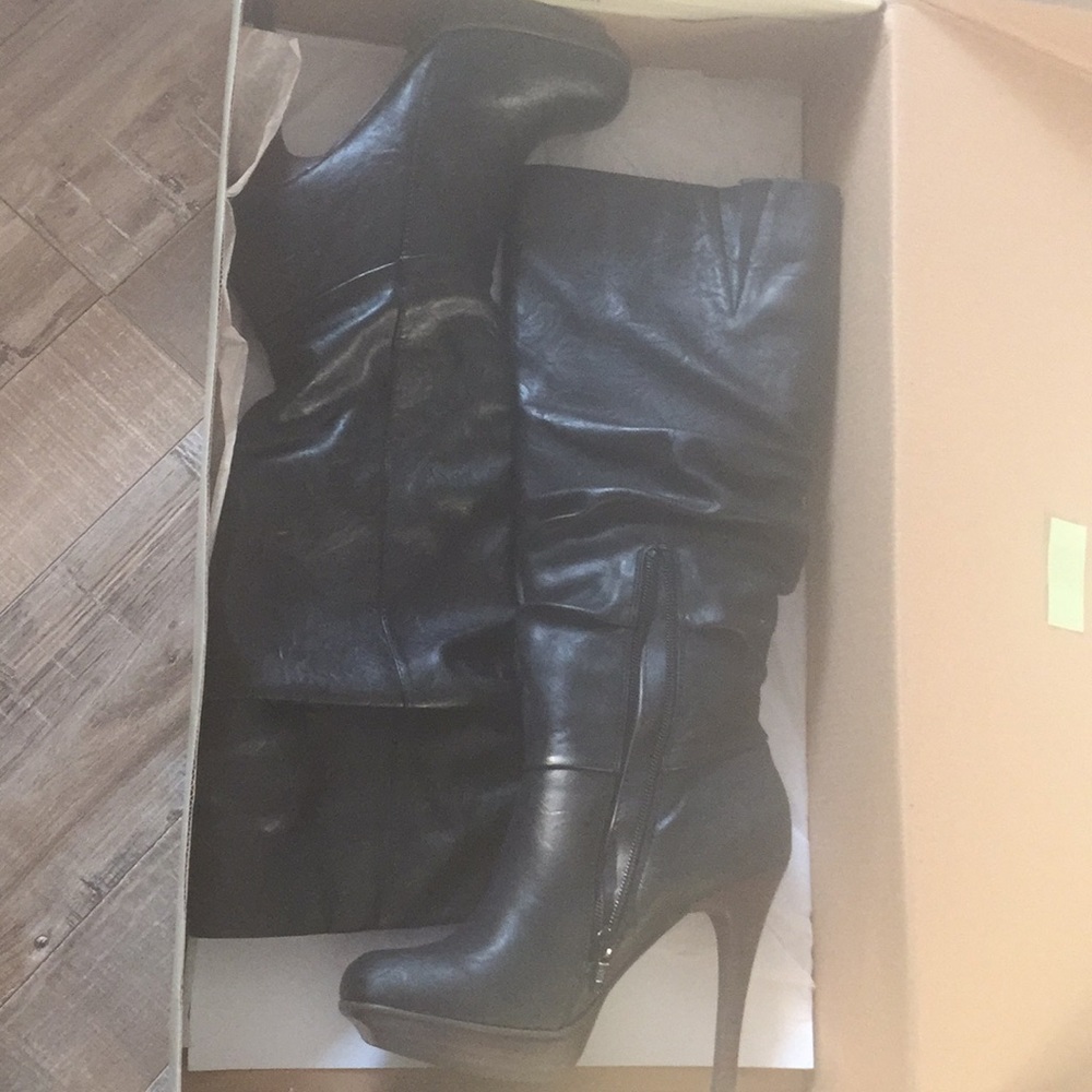 Black knee high heeled boots